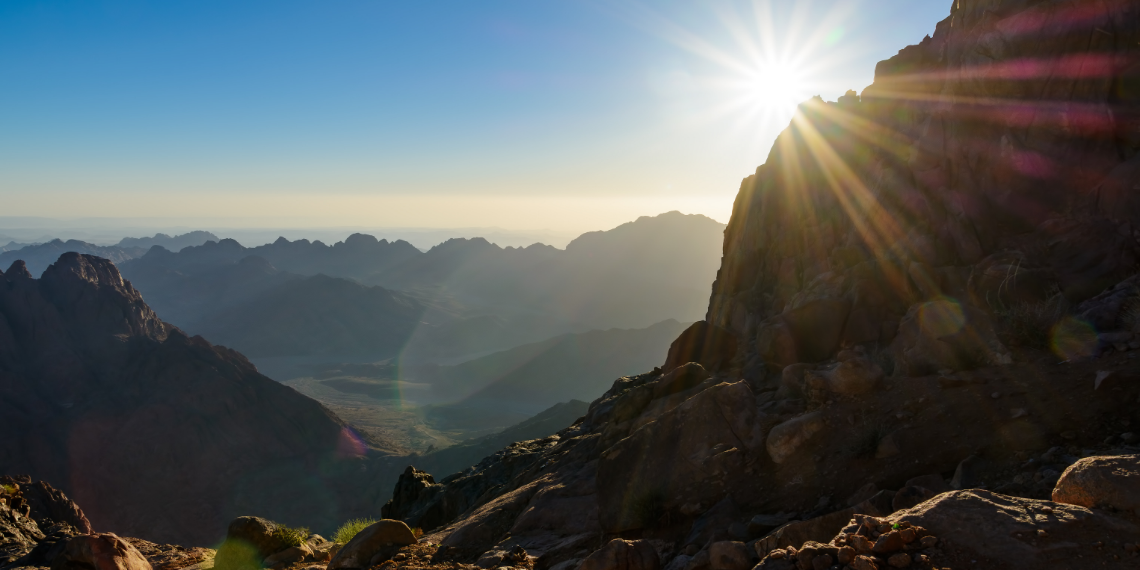 Mountains near Mt Sinai with the sun shining out from behind the side of a mountain
