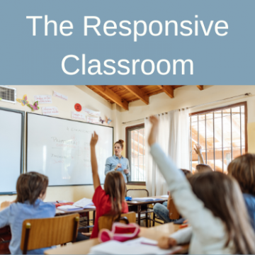 An elementary school classroom with teacher and kids holding up their hands