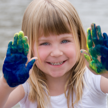 Young camper with fingerpaint
