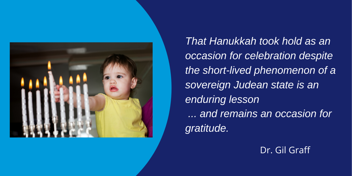 baby with hanukkah candles